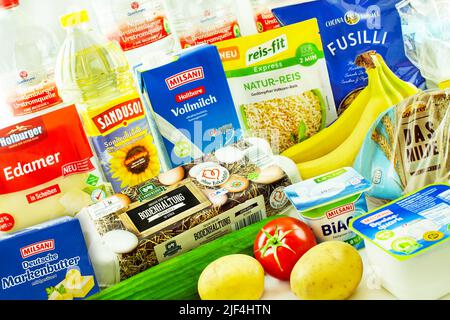 Hamburg, Germany -  June 24   2022:  Various German discounter basic foods on white background Stock Photo