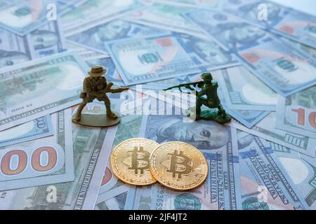 War criminals using btc or bitcoin or cryptocurrency concept background photo. Two bitcoin symbols on the US dollars with two figurine soldier. Select Stock Photo