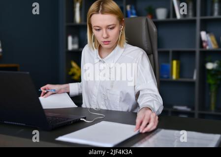 Woman doing paperwork in office. Stock Photo