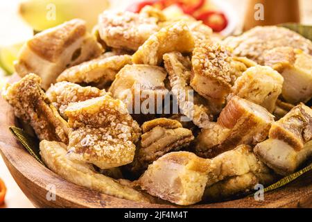 Crackling bowl, Brazilian appetizer made by frying bacon, leather or meat and lots of fat, taken from the pork belly. Stock Photo