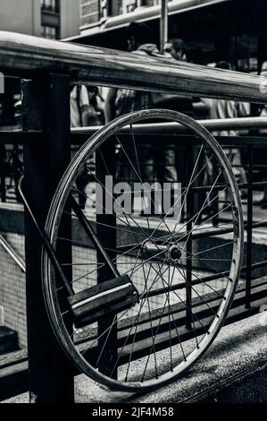 Chained bicycle rim with a lock in the city Stock Photo
