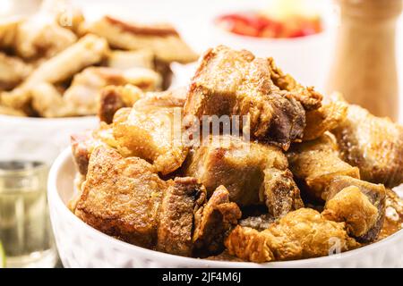 Crackling bowl, Brazilian appetizer made by frying bacon, leather or meat and lots of fat, taken from the pork belly. Stock Photo