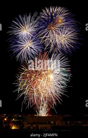 Explosion of bright colors of fireworks on the night of celebration. Stock Photo