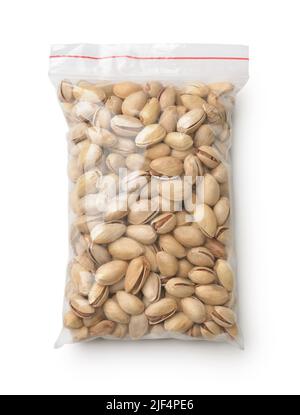 Top view of dried pistachios in clear plastic bag isolated on white Stock Photo