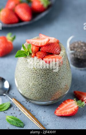 Vegan Chia Seed Pudding With Green Tea Matcha And Strawberries In Glass. Closeup View. Healthy Dessert For Breakfast Stock Photo