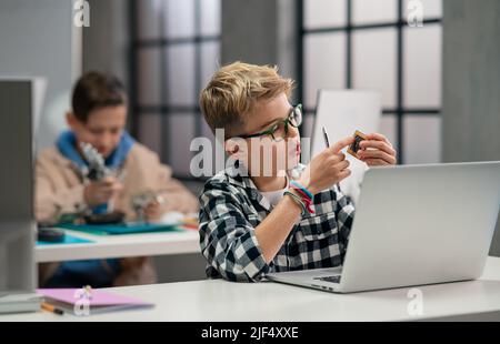 Pupils at school working with electronics component at robotics classroom. Stock Photo