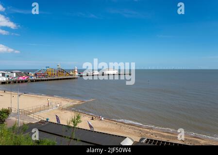 Clacton Pier, stretching out into the North Sea off Clacton on Sea, Essex, UK. Gunfleet Sands offshore wind farm on horizon Stock Photo