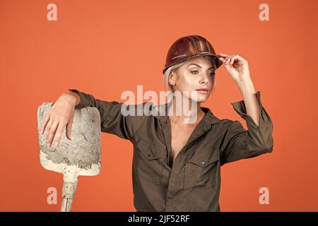 a bit tired. building and construction. lady architect worker. engineer on orange background. Stock Photo