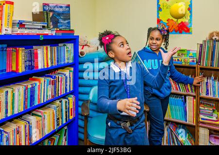 African-American girls play in the library during an after-school program, Feb. 28, 2013, in Columbus, Mississippi. Stock Photo