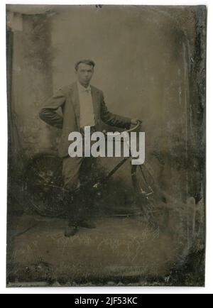 Antique circa 1860 tintype photograph, man with bicycle. Location unknown, USA. SOURCE: ORIGINAL TINTYPE Stock Photo