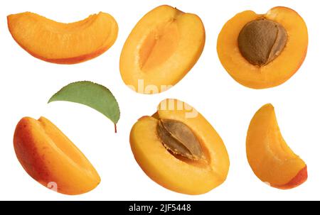 Close up studio macro photo of half and sliced ripe floating apricots on isolated white background. Stock Photo