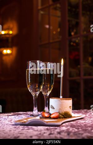 two glasses of sparkling wine and tiramisu dessert on the table Stock Photo