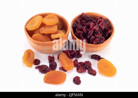 Dried apricots and cranberries isolated on bright background. Dried fruit concept. Close up view. Stock Photo