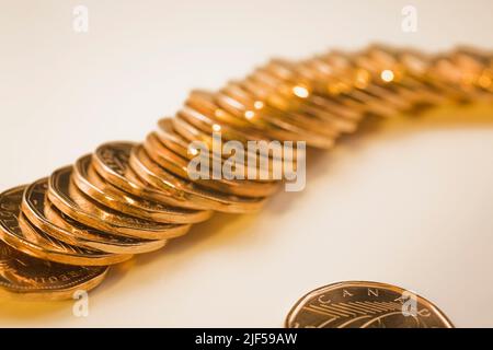 Row of Canadian one dollar coins on white background. Stock Photo