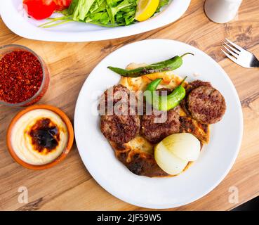 Turkish traditional kofte. Spicy kebab with pita and vegetables Stock Photo