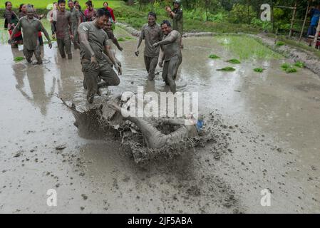 Kathmandu, Nepal. 29th June, 2022. People play in mud water in a paddy field during the National paddy day celebration. Nepalese farmers celebrate National Paddy Day with various events that mark the start of the annual rice planting season. (Photo by Bivas Shrestha/SOPA Images/Sipa USA) Credit: Sipa USA/Alamy Live News Stock Photo