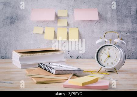Time managament concept in office. Books, notepads with stickers Stock Photo