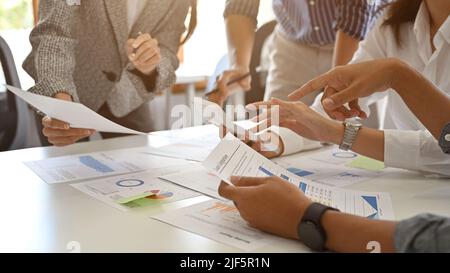 Close-up image, A businesspeople hands on the report over the meeting table. A businesspeople working together, having a business meeting. Stock Photo