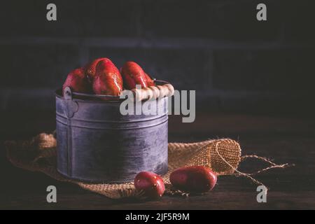 Organic raw red potatoes on wooden background Stock Photo