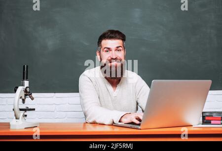 Bearded tutor near chalkboard. Student Studying Hard Exam. Teachers day. Tutor. Science and education concept. School day. Education. Stock Photo