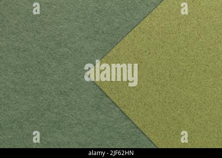 Texture of dark green and olive paper background, half two colors with arrow, macro. Structure of dense khaki craft cardboard. Felt backdrop closeup. Stock Photo