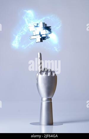 Mechanical robot arm or hand interacts with futuristic digital technologies. Concept of virtual, augmented reality, robots and artificial intelligence Stock Photo