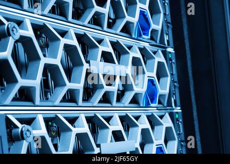 Closeup Of Modern Hard Drives In Illuminated Blue Datacenter Stock Photo