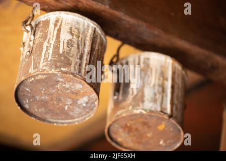 Enkhuizen, Netherlands. June 2022. Close up of old paint cans on the ceiling of a paint store. High quality photo Stock Photo