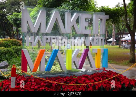 MANILA, PHILIPPINES - DECEMBER 7, 2017: Make It Happen, Make It Makati sign at Ayala Triangle, Makati, Metro Manila. Metro Manila is one of the bigges Stock Photo