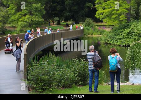 KEW, UK - JULY 15, 2019: People visit Kew Gardens in Greater London. Royal Botanic Gardens are designated as UNESCO World Heritage Site. Stock Photo