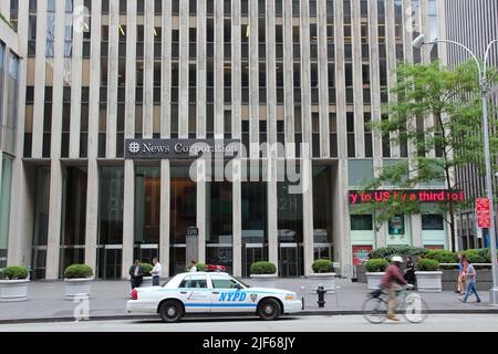 NEW YORK, USA - JULY 4, 2013: People walk by News Corporation at 6th Avenue in New York. Famous News Corporation was divided into News Corp and 21st C Stock Photo