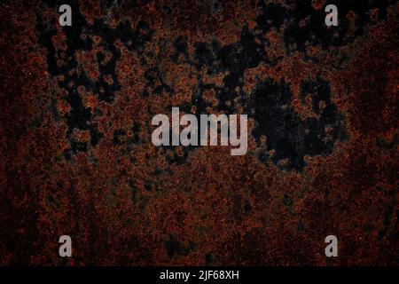 Rusty metal dark background. Industrial metal plate grungy texture. Rusty worn steel plate. Stock Photo