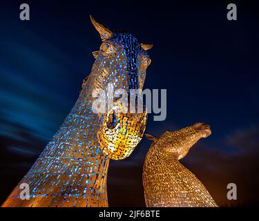 The Kelpies are 30-metre-high horse-head sculptures by artist Andy Scott and are located in Helix Park Falkirk next to the Forth and Clyde Cana Stock Photo