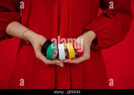 Woman holding red insulating tape on white background, closeup Stock ...