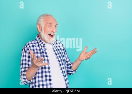 Photo of excited crazy impressed pensioner man see huge shopping bargains ad isolated on teal color background Stock Photo