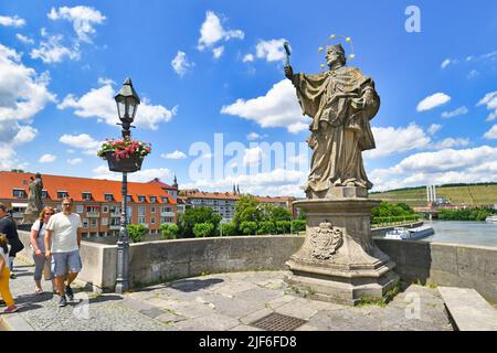 Würzburg, Germany - June 2022: Sculpture of saint of John of Nepomuk at famous old Main bridge called 'Alte Mainbrücke' Stock Photo