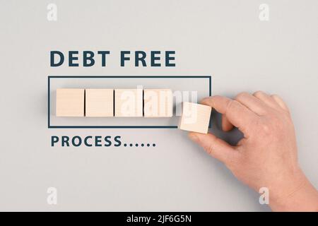 The words debt free in process are standing next to the loading bar, ending credit payments and bank loans, financial freedom Stock Photo