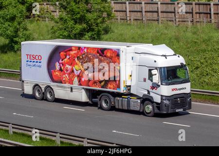XPO LOGISTICS TRACTOR UNIT with TESCO refrigerated supermarket trailer driving on the M6 Motorway UK Stock Photo