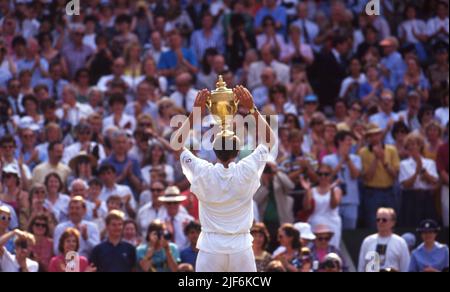 Wimbledon winner Michael Stich holds aloft the Men's Winner Trophy to the crowd on Centre Court in 1991   Photo by Tony Henshaw Stock Photo