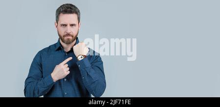 The elegance of punctuality. Bearded man point at wristwatch. Punctuality concept. Business time. Man face portrait, banner with copy space.