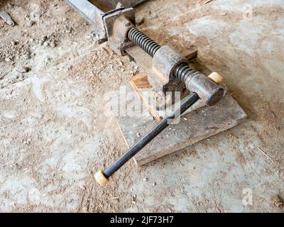 The old clamps tool on the dirty ground for use in the small site for extension the rural house, front view with the copy space. Stock Photo