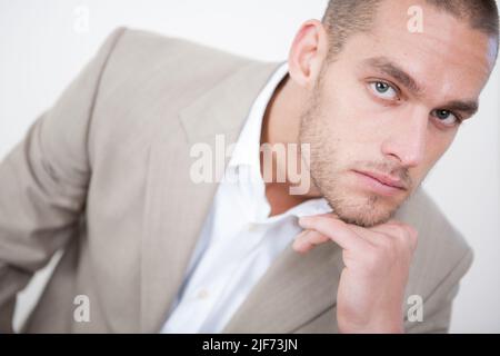 Business Confidence. A strong fashion portrait of a smartly dressed handsome male model. From a series of images with the same model. Stock Photo