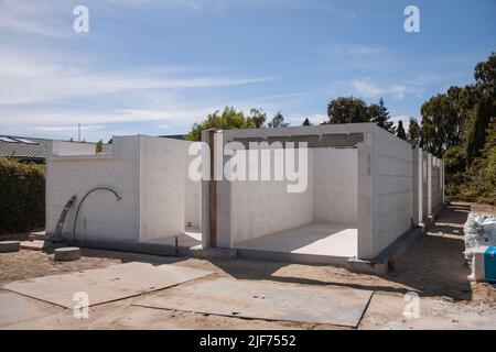 Construction site of a private family house. Unfinished house made of aerated concrete blocks. Only foundation and walls are showing. Real estate deve Stock Photo