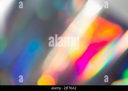 Rainbow holographic bokeh background. Multicolored overflows of color. Stock Photo