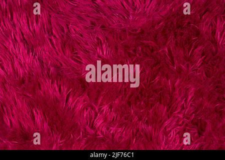 Dark burgundy fur texture with long pile. Stock Photo