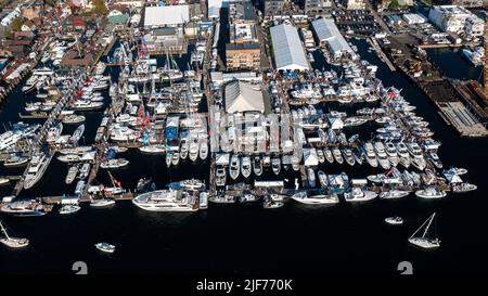 Aerial stock photos of the Newport Harbor, boats docked and moored in late afternoon sun at the Newport International Boat Show, Safe Harbor Shipyard. Stock Photo