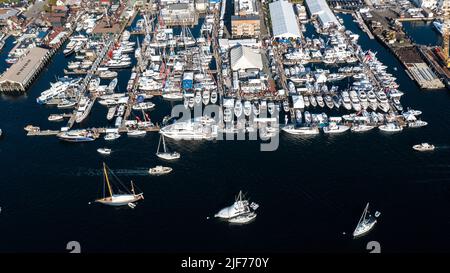 Aerial stock photos of the Newport Harbor, boats docked and moored in late afternoon sun at the Newport International Boat Show, Safe Harbor Shipyard. Stock Photo