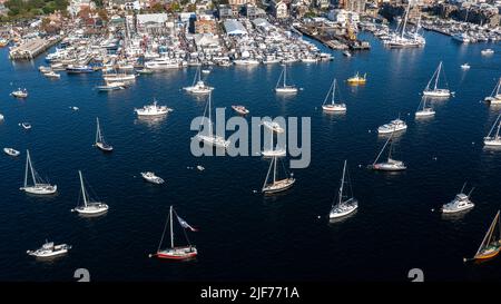 Aerial stock photos of the Newport Harbor, boats docked and moored in late afternoon sun at the Newport International Boat Show, Safe Harbor Shipyard. Stock Photo