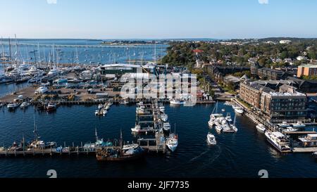 Aerial stock photos of the Newport Harbor, boats docked and moored in late afternoon sun at the Newport International Boat Show, Safe Harbor Shipyard. Stock Photo