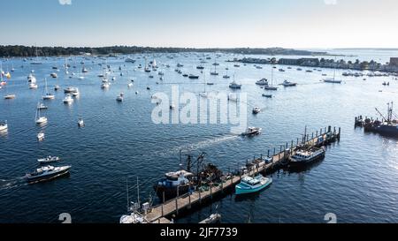 Aerial stock photos of the Newport Harbor, Boats docked and moored in late afternoon sun at the Newport International Boat Show. Safe Harbor Shipyard Stock Photo